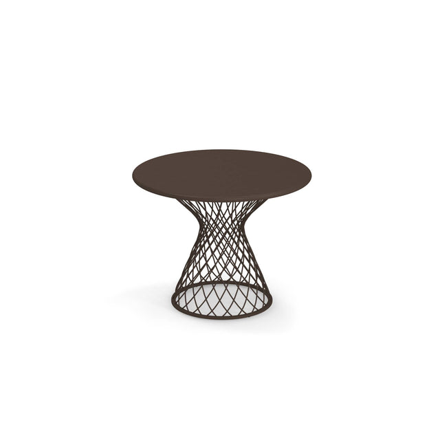 A round, dark brown Como Side Table with a solid top and an open, steel wire lattice-style base that narrows toward the middle and widens at the bottom, giving it a modern, sculptural look. Perfect for indoor/outdoor spaces, it sits alone on a white background.