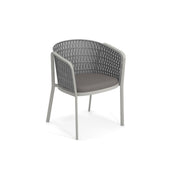 A modern gray Carousel Armchair with a rounded backrest and armrests featuring a woven synthetic flat rope pattern. Supported by an aluminum tubular frame and padded dark gray seat cushion, it blends metal and synthetic materials for a sleek, contemporary look.