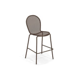 A tall, brown steel mesh barstool with a round mesh backrest and seat. This minimalistic, industrial Ronda Stacking Barstool features four slender legs, horizontal supports, and a built-in footrest. Perfect as an outdoor indoor barstool.