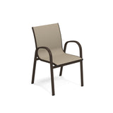 A beige Holly Stacking Armchair with an aluminum frame. This outdoor chair features curved armrests and legs and a slightly reclined backrest. The fabric seat and backrest accentuate its modern, minimalist look.