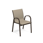 A beige Holly Stacking Armchair with an aluminum frame. This outdoor chair features curved armrests and legs and a slightly reclined backrest. The fabric seat and backrest accentuate its modern, minimalist look.