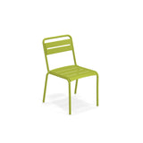 A modern green outdoor chair with a simple design, featuring an e-coated steel slatted seat and backrest, gently curved legs, and no armrests. The Star Stacking Side Chair is positioned slightly angled to the left against a plain white background.