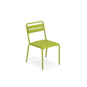 A modern green outdoor chair with a simple design, featuring an e-coated steel slatted seat and backrest, gently curved legs, and no armrests. The Star Stacking Side Chair is positioned slightly angled to the left against a plain white background.