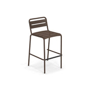 The Star Stacking Barstool is a tall, minimalist steel barstool with a brown metal frame. Its seat and backrest feature parallel horizontal slats, a rectangular footrest, and it’s perfect as an outdoor barstool against a plain white background.