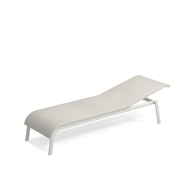 A minimalist, modern Tiki Chaise lounge with a light beige cushion and a sleek white aluminum frame. The gently curved seat, slightly raised backrest, and clean silhouette create a stylish, stackable outdoor chaise perfect for relaxing.