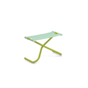 A small, modern Snooze Ottoman folding stool with a green metal frame and a light blue-and-white striped EMU-Tex fabric seat, set against a plain white background. The X-shaped frame and rounded foot caps make it ideal for outdoor/indoor use.