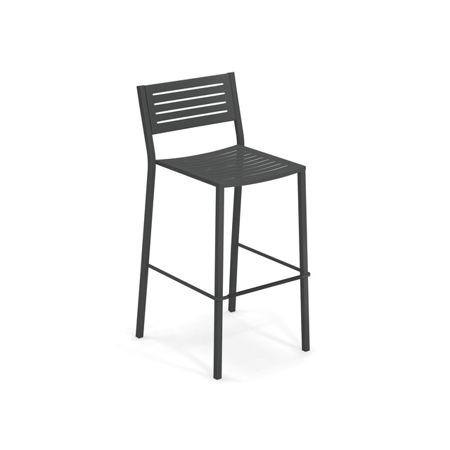 The Segno Stacking Barstool is a modern black steel barstool with a slatted seat and backrest, four straight legs, and a footrest. Its sleek, minimalist design makes it ideal as an outdoor barstool, set against a plain white background.