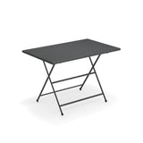 The Arc En Ciel Folding Table features a rectangular, dark gray e-coated steel top and slender metal legs crossing in an X-shape. Two horizontal support bars connect the legs, making it a perfect outdoor/indoor table against a plain white background.