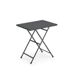 A small, rectangular, black Arc En Ciel Folding Table with thin e-coated steel legs in an X-shape, allowing for easy folding and portability. The flat top and plain white background highlight this versatile outdoor folding table.
