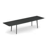 A long, modern black Plus4 Extension Table with four slim legs, shown on a white background. This sleek, minimalist rectangular extension table features visible seams, suggesting it is extendable, perfect for both outdoor and indoor spaces.
