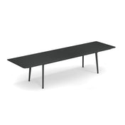 A long, modern black Plus4 Extension Table with four slim legs, shown on a white background. This sleek, minimalist rectangular extension table features visible seams, suggesting it is extendable, perfect for both outdoor and indoor spaces.