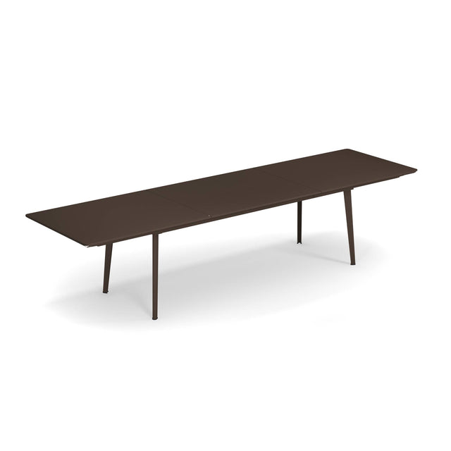 A long, rectangular, dark brown Plus4 Extension Table with a solid steel top and four slightly angled legs. This sleek, modern table has a smooth, extendable surface, perfect for outdoor/indoor use against a plain white background.
