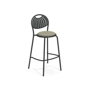 A tall steel barstool with a black metal frame, curved legs, and a light grey circular seat. The backrest features a fan-like pattern, and a footrest connects the front legs. Perfect as an indoor outdoor barstool, it stands against a white background.