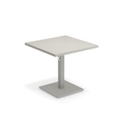 A modern, minimalist Lock Table with a light-colored tabletop. Suitable for outdoor/indoor use, it features a single central support column and a flat rectangular base, both in matching gray with an e-coated powder coat finish for durability.