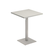 A modern Lock Table, this square table features a flat, light gray top and a central metal pedestal leg on a square base. Its simple, minimalist design with clean lines and matte finish suits both outdoor/indoor settings. Background is plain white.