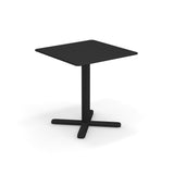 A small, modern black solid steel table with a single central leg and four-pronged base. Minimalistic and functional, this tilt top table stands on a white background, casting a soft shadow beneath it.