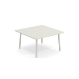 A small, square Darwin Low Table with a light-gray steel top and rounded edges sits on four cylindrical legs against a plain white background. Its minimalist design is perfect as an outdoor table for modern interiors or patios.