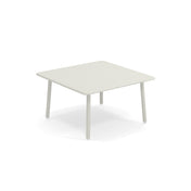 A small, square Darwin Low Table with a light-gray steel top and rounded edges sits on four cylindrical legs against a plain white background. Its minimalist design is perfect as an outdoor table for modern interiors or patios.