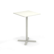 A small, modern white square Darwin Tilt Top Bar Table with a thin central pedestal and four-pronged base stands alone on a plain white background. The minimalist, functional design makes it an ideal outdoor bar table.