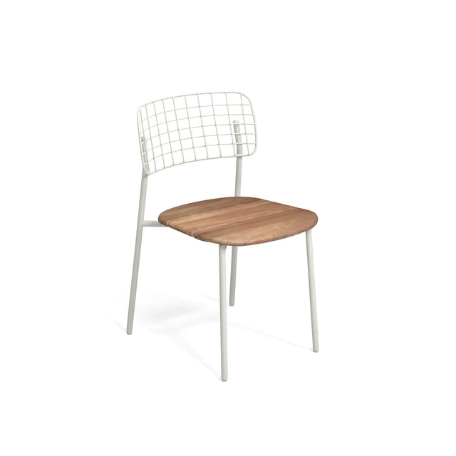 The Lyze Stacking Side Chair features thin, white metal legs, a stainless steel back with a wire-grid design, and a smooth, light wood seat. Its minimalist, contemporary style makes it an ideal outdoor/indoor chair against any setting.