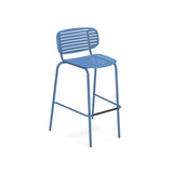 A modern blue steel barstool with a slatted seat and backrest, thin legs, and a black footrest bar; the minimalist, lightweight design makes this outdoor barstool perfect for versatile spaces, set against a plain white background.