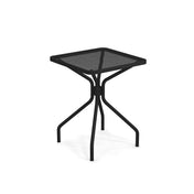 The Cambi Table is a small, square, black metal table with a mesh top. Its four slightly angled legs connect in the center for stability, offering a modern, minimalist design that's perfect for both outdoor/indoor use.