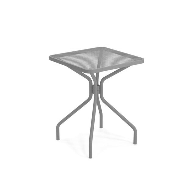 The Cambi Table is a gray, square metal outdoor table with a mesh top and four curved legs that meet at the center, crafted in a minimalist style. It stands alone on a plain white background.