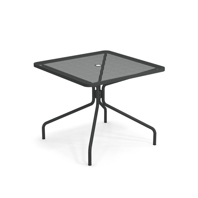 The Cambi Table is a modern, minimalist black metal square table with a mesh top, four outward-angled legs, and a central umbrella hole. Perfect for outdoor/indoor use, it's shown on a white background.