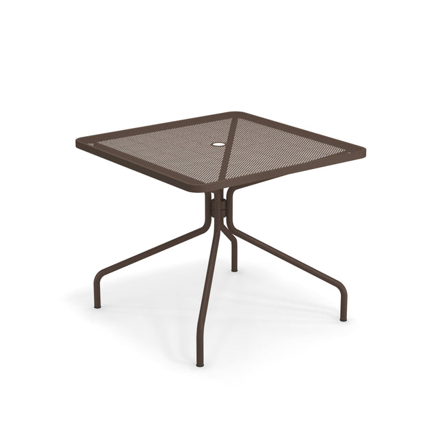 The Cambi Table is a brown metal square table with a mesh top, central umbrella hole, and four slightly curved legs that meet at a central support. Its minimal, modern design makes it perfect for outdoor/indoor use.