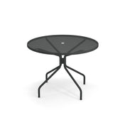 A round, black Cambi Table with a mesh top and a central hole for an umbrella. Its four legs angle outward and curve at the base for stability. Suitable as an outdoor/indoor table, it features a plain white background.