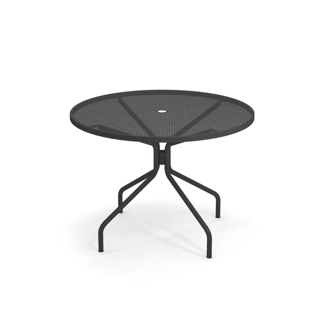 A round, black Cambi Table with a mesh top and a central hole for an umbrella. Its four legs angle outward and curve at the base for stability. Suitable as an outdoor/indoor table, it features a plain white background.