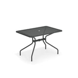 A rectangular mesh outdoor table with a black metal tabletop and four angled legs. Featuring a central hole for an umbrella, this drink table combines simple, modern design with stability, set against a white background.