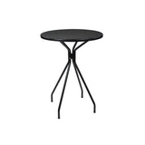 A small, round Cambi Bar Table with a black mesh top and four slender, angled legs converging at the center. This minimalist, modern outdoor bar table stands elegantly against a plain white background.