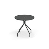 A round table with umbrella hole, this solid steel table features a modern, minimalist design with four angled legs and a sleek black finish—perfect as an outdoor table for any contemporary space. Photographed against a white background.