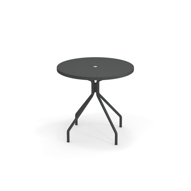 A round table with umbrella hole, this solid steel table features a modern, minimalist design with four angled legs and a sleek black finish—perfect as an outdoor table for any contemporary space. Photographed against a white background.