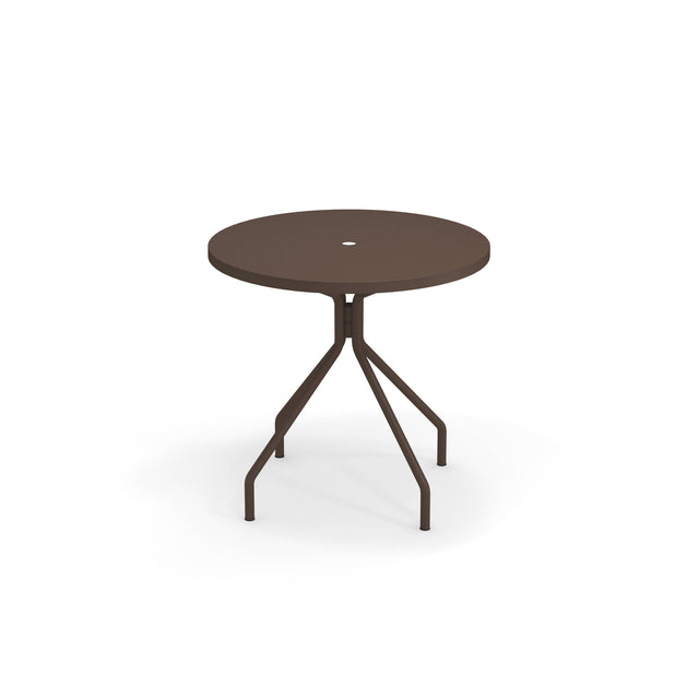 A round, dark brown solid steel outdoor table with a central hole on the tabletop, supported by four angled legs that connect to a central vertical post. The table stands on a white background with a faint shadow beneath it.