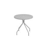 A round, light gray solid steel table with a smooth top and a small center umbrella hole. It has three angled legs extending outward and downward to the floor. This versatile outdoor indoor table stands against a plain white background.