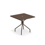 A square, brown outdoor solid table made in Italy with a flat steel top and a small round hole in the center. It features four legs that curve outward, connected to a central support beneath the tabletop, all set against a plain white background.