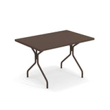 A rectangular brown indoor outdoor table with a flat top and four metal legs that angle outward, connected by a crossbar for support, placed on a white background. The simple, functional design makes it suitable for versatile use.