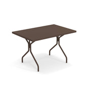 A rectangular brown indoor outdoor table with a flat top and four metal legs that angle outward, connected by a crossbar for support, placed on a white background. The simple, functional design makes it suitable for versatile use.