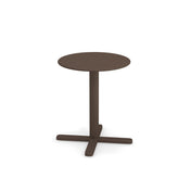 A small, round, brown tilt top table with a single central pedestal and a four-legged base, standing on a plain white background. The design is simple and modern, featuring clean lines and a smooth surface.