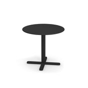 A small, round, black Darwin Tilt Top Table with a flat top and a single central support that splits into a four-legged cross-shaped base. This solid steel dining table is simple, modern, and set against a plain white background.