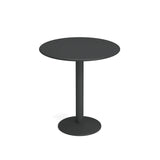 A simple, round black bistro table with a single central steel pedestal leg and a circular flat base, shown on a white background. The design is modern and minimalist, featuring a smooth tabletop and clean lines.