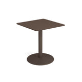 A small, modern bistro table with a flat brown tabletop, a single central steel pedestal, and a round flat base. Its minimalistic design features smooth edges, perfect for both outdoor and indoor settings against a plain white background.