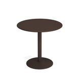 A simple, modern round bistro table with a dark brown top and a single central steel pedestal base. The pedestal is cylindrical, supporting the tabletop and connecting to a flat, circular base. The background is plain white.