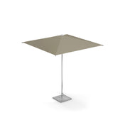 A large, square shade umbrella with a taupe, pocket less canopy is supported by a slim anodized aluminum pole and anchored by a square, textured stone base. The umbrella is open and standing alone against a plain white background.