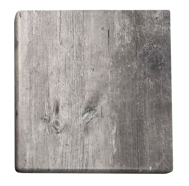 A square wooden board with rounded corners and a weathered gray surface evokes a rustic, aged look. Visible wood grain and subtle scratches create character, making it ideal as an outdoor table top with natural charm. Plain white background highlights its details.
