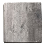 A square, rustic wooden cutting board with visible wood grain, knots, and a weathered texture—perfect for an outdoor table top. The faded grayish-brown wood features a rounded top left corner and worn edges, set against a white background.