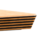 Close-up of an Epicurean cutting board with a triangular shape, featuring alternating horizontal black and natural wood stripes. The smooth, light-colored top surface stands out against a plain, light gray background.