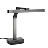 A modern, black multi-position heat lamp with a rectangular base, an adjustable vertical arm, and a horizontal light bar. Its sleek, angular design features clean lines and a matte finish. A power cord extends from the back of the base.